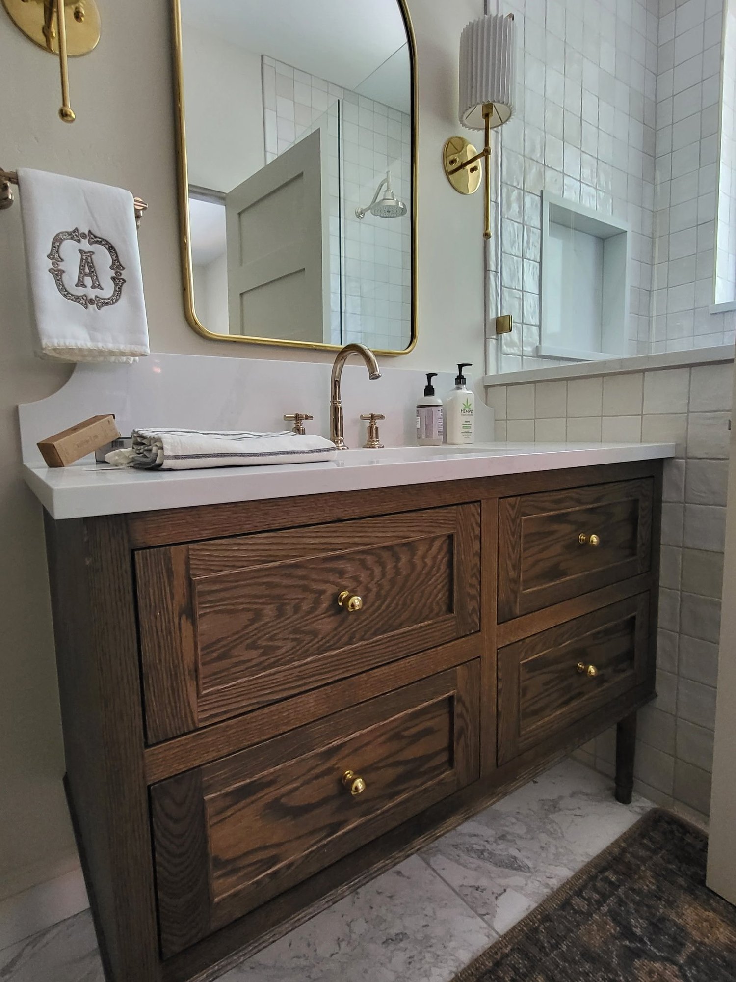Furniture-style dark oak bath vanity with inset shaker doors